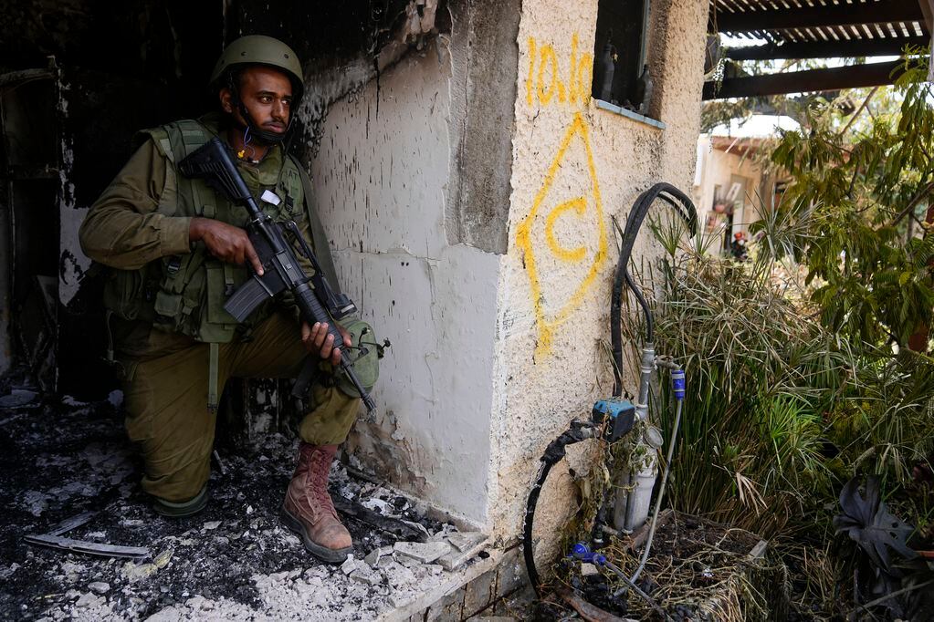 ARCHIVO - Un soldado israelí toma posición en el kibbutz Kfar Azza, israel, 10 de octubre de 2023. Milicianos de Hamas tomaron Kfar Azza el sábado anterior, mataron a muchhos israelíes y se llevaron cautivos. (AP Foto/Ohad Zwigenberg)