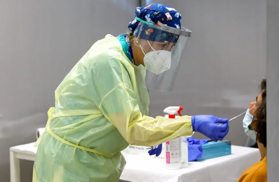 A healthcare worker wearing personal protective equipment (PPE) collects a swab sample from a passenger at the Covid-19 rapid test facility at Fiumicino Airport in Rome, Italy, on Friday, Sept. 25, 2020. A handful of airports are implementing trials of quick-fire coronavirus tests, working with airlines to push technologies still being developed as a way to revive stunted international air travel. Photographer: Alessia Pierdomenico/Bloomberg