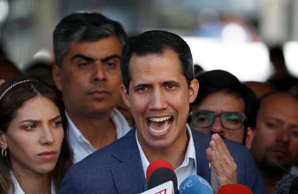 Venezuelan opposition leader Juan Guaido, who many nations have recognized as the country's rightful interim ruler, talks to the media after attending a religious event in Caracas, Venezuela February 10, 2019. REUTERS/Carlos Garcia Rawlins