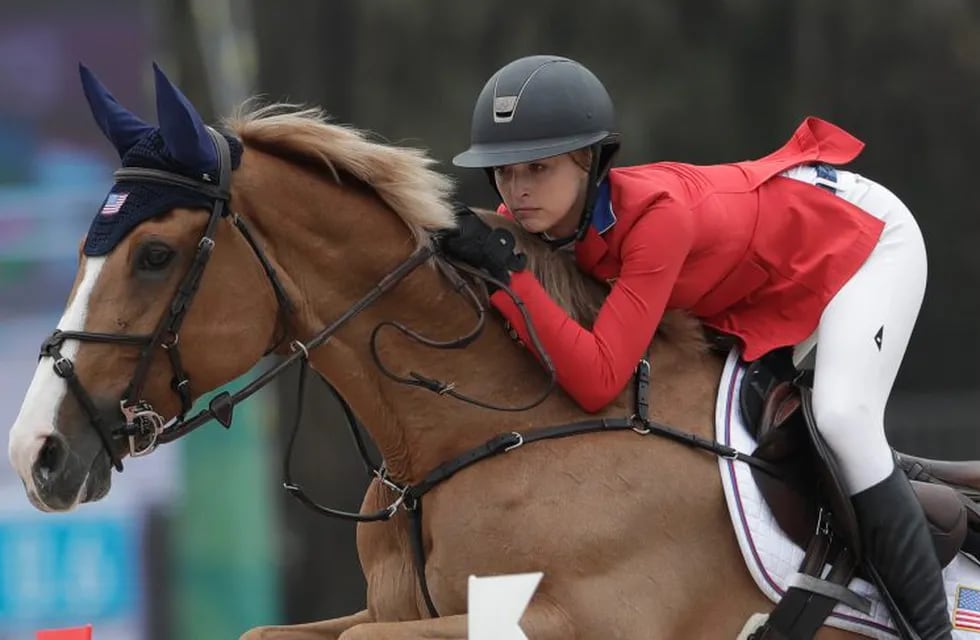 Eve Jobs of the U.S. competes on Venue d'Fees des Hazalles in the equestrian jumping individual - 2nd qualifier at the Pan American Games in Lima, Peru, Wednesday, Aug. 7, 2019. (AP Photo/Silvia Izquierdo)
