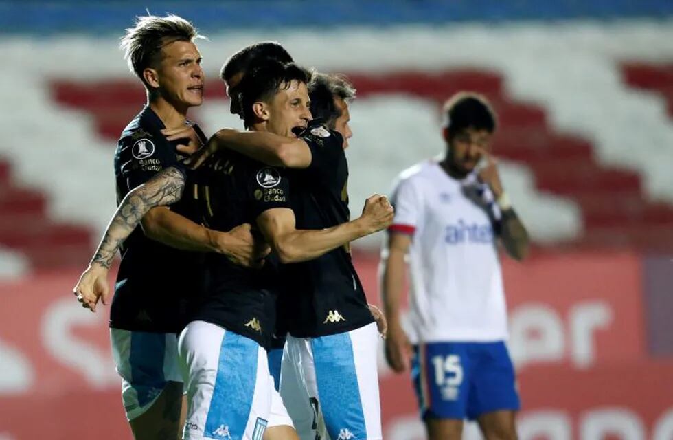 Hector Fertoli of Argentina's Racing Club, second left, celebrates scoring his side's second goal with teammates during a Copa Libertadores soccer match against Uruguay's Nacional in Montevideo, Uruguay, Wednesday, Sept. 30, 2020. (Mariana Greif/Pool via AP)