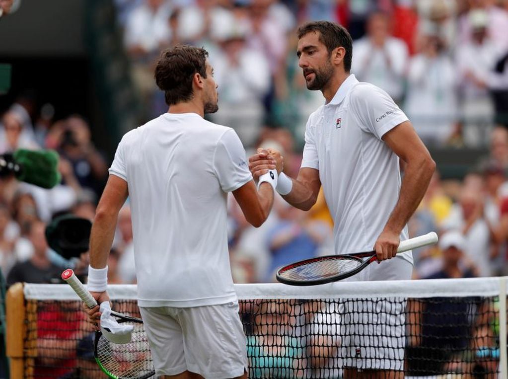 Tennis - Wimbledon - All England Lawn Tennis and Croquet Club, London, Britain - July 5, 2018 Argentina's Guido Pella shakes hands with Croatia's Marin Cilic after winning their second round match  REUTERS/Andrew Couldridge