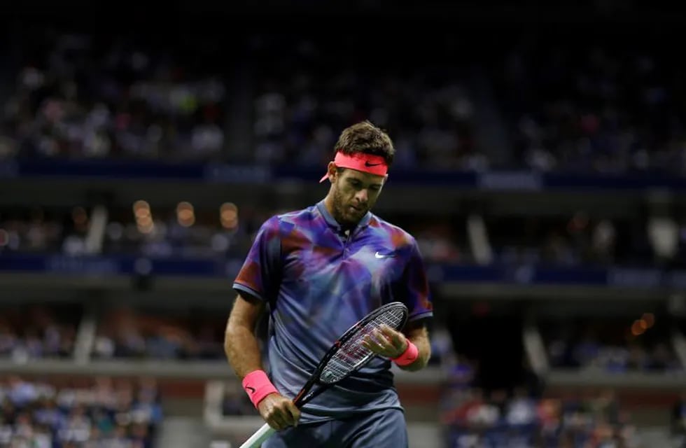 Juan Martin del Potro, of Argentina, adjusts the strings on his racket betweens serves from Rafael Nadal, of Spain, during the semifinals of the U.S. Open tennis tournament, Friday, Sept. 8, 2017, in New York. (AP Photo/Andres Kudacki)
