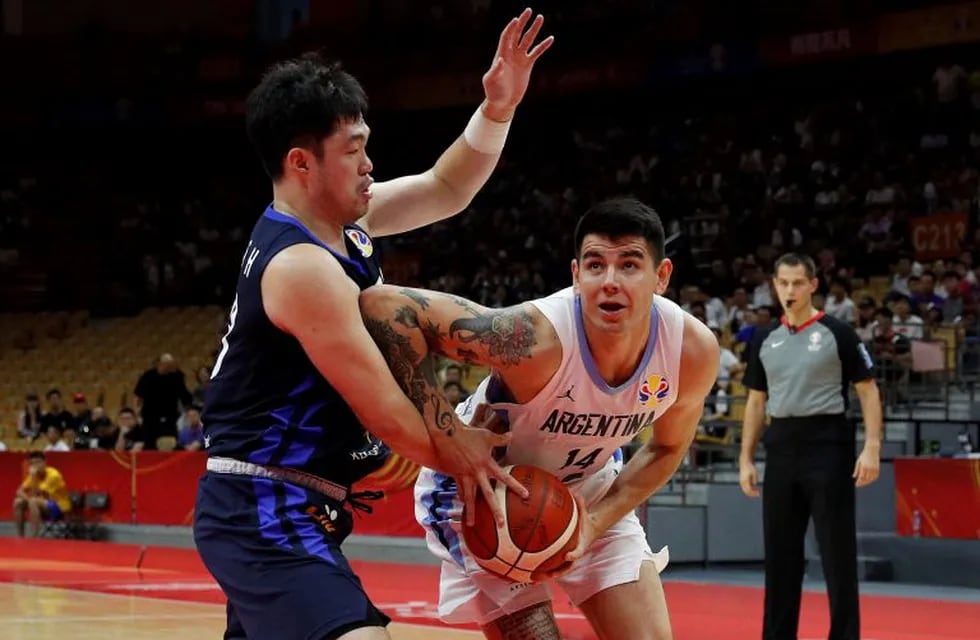 Gabriel Deck of Argentina, right, is tackled by Lee Seounghyun of South Korea during their group phase basketball game in the FIBA Basketball World Cup, at the Sport Center in Wuhan in central China's Hubei province, Saturday, Aug. 31, 2019. (AP Photo/Andy Wong)