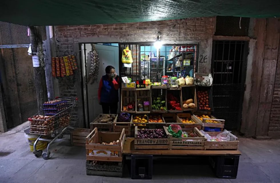 A greengrocer waits for customers at her store of the Villa 1-11-14 shantytown during the lockdown imposed by the government against the spread of the new coronavirus, COVID-19, in Buenos Aires, on May 26, 2020. (Photo by JUAN MABROMATA / AFP)