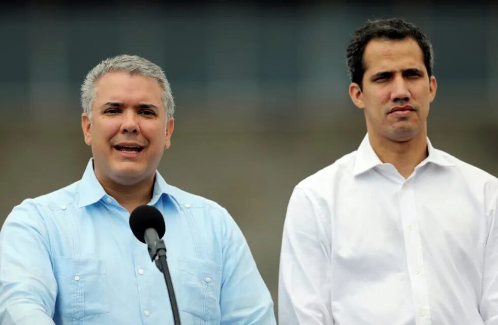 Colombia's President Ivan Duque speaks to the media alongside Venezuelan opposition leader Juan Guaido, who many nations have recognized as the country's rightful interim ruler in the area of a warehouse where humanitarian aid for Venezuela has been collected in Cucuta, Colombia, February 23, 2019.  REUTERS/Luisa Gonzalez