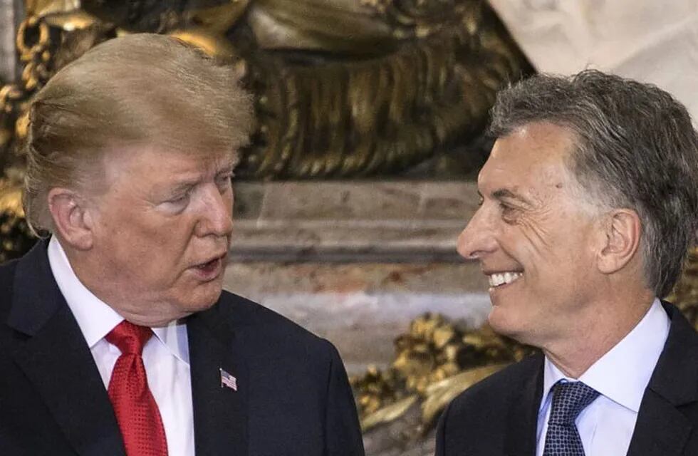 US President Donald Trump (L) is welcomed by Argentina's President Mauricio Macri at Casa Rosada presidential house in Buenos Aires, on November 30, 2018, to hold a meeting in the sidelines of the G20 Leaders' Summit. - G20 powers open two days of summit talks on Friday after a stormy buildup dominated by tensions with Russia and US President Donald Trump's combative stance on trade and climate fears. (Photo by RAGGIO ALBERTO / AFP)