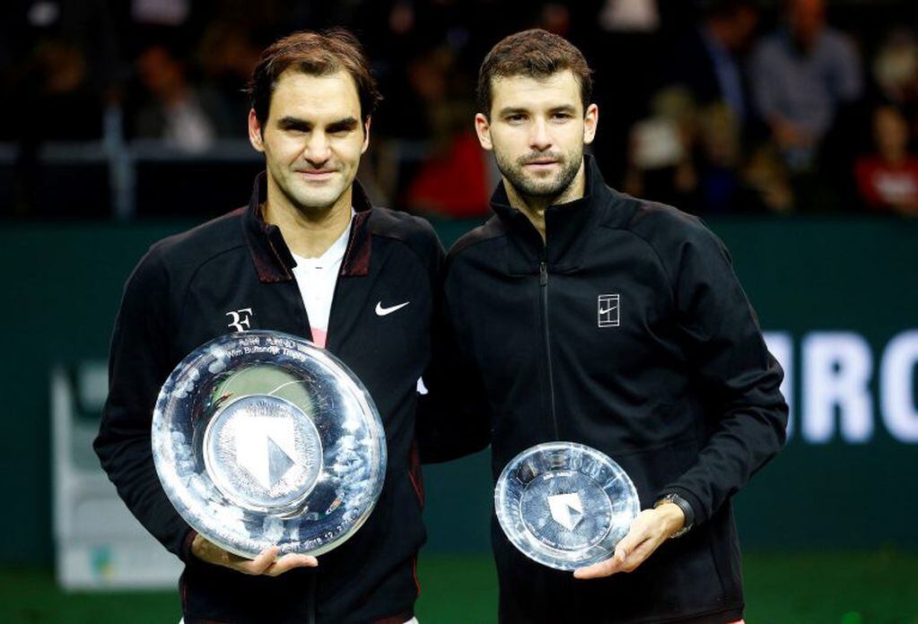 Tennis - ATP 500 - Rotterdam Open - Final - Ahoy , Rotterdam, Netherlands - February 18, 2018 - Roger Federer of Switzerland and Grigor Dimitrov of Bulgaria hold their trophies. REUTERS/Michael Kooren