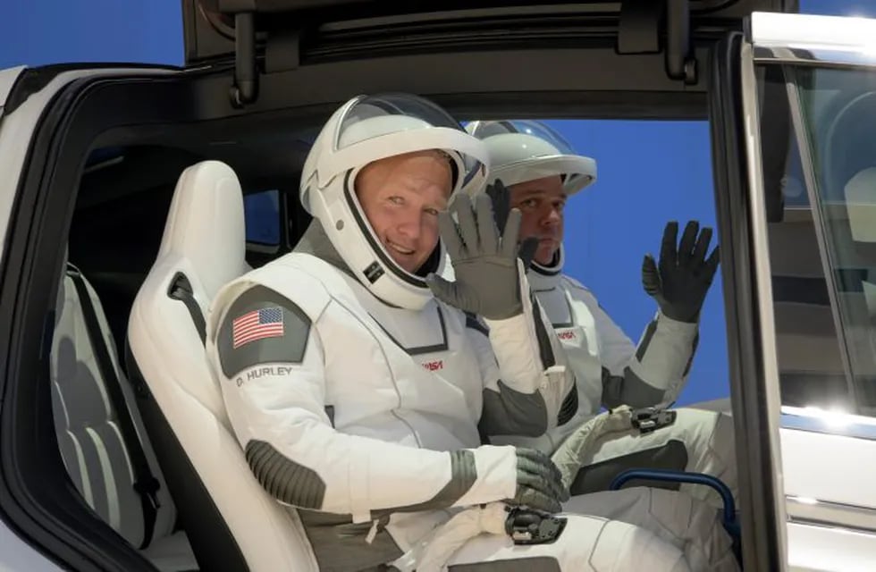 NASA astronauts Douglas Hurley, left, and Robert Behnken, wearing SpaceX spacesuits, depart the Neil A. Armstrong Operations and Checkout Building for Launch Complex 39A during a dress rehearsal prior to the Demo-2 mission launch, Saturday, May 23, 2020, at NASA's Kennedy Space Center in Cape Canaveral, Fla. The SpaceX Falcon 9 rocket, that will send two astronauts to the International Space Station for the first crewed flight from the U.S. in nearly a decade., is scheduled for launch on Wednesday, May 27. (Bill Ingalls/NASA via AP)