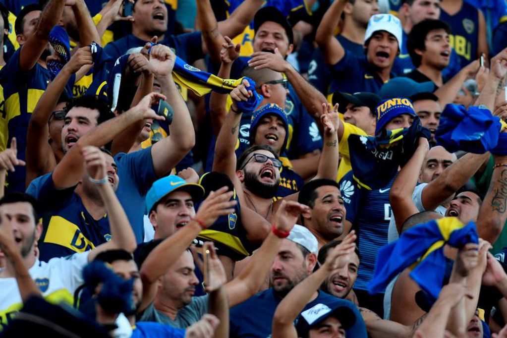 Boca Juniors supporters cheer for their team during their Supercopa Argentina 2018 final football match against River Plate at Malvinas Argentinas stadium in Mendoza, Argentina, on March 14, 2018. / AFP PHOTO / Andres Larrovere