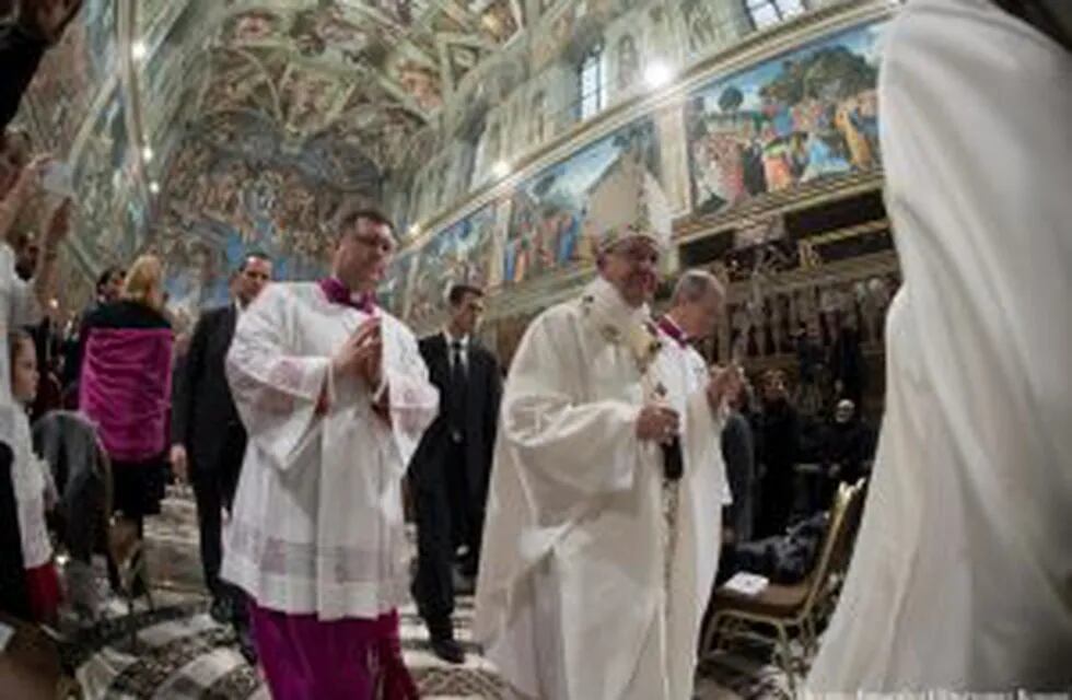 This handout picture released by the Vatican press office shows Pope Francis celebrating baptisms on January 8, 2017 at the Sistine Chapel in Vatican. Pope Francis encouraged women to feel free to breastfeed their children in the church. 