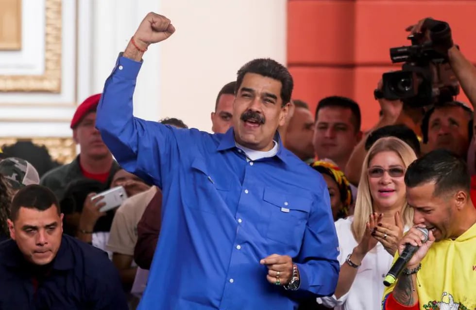 Venezuelan president Nicolas Maduro, with his wife Cilia Flores, speaks during a march for International Youth Day in Caracas, Venezuela on February 12, 2020. (Photo by CRISTIAN HERNANDEZ / AFP)