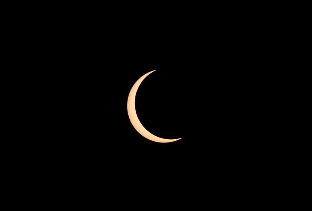 Momento en que la luna se coloca frente al sol durante el eclipse solar del 21 de junio 2020. (Foto:AFP)