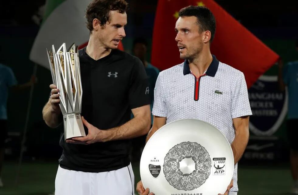 Winner's Andy Murray of Britain, left, chats with Roberto Bautista Agut of Spain after the award ceremony for the men's singles final match at the Shanghai Masters tennis tournament at Qizhong Forest Sports City Tennis Center in Shanghai, China, Sunday, Oct. 16, 2016. (AP Photo/Andy Wong)