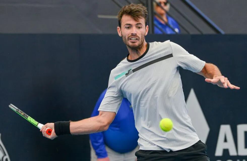 Juan Ignacio Londero of Argentina hits a return against Daniel Evans of Britain during their men's singles first round match at the Adelaide International tennis tournament in Adelaide on January 13, 2020. (Photo by Brenton EDWARDS / AFP) / IMAGE RESTRICTED TO EDITORIAL USE - STRICTLY NO COMMERCIAL USE