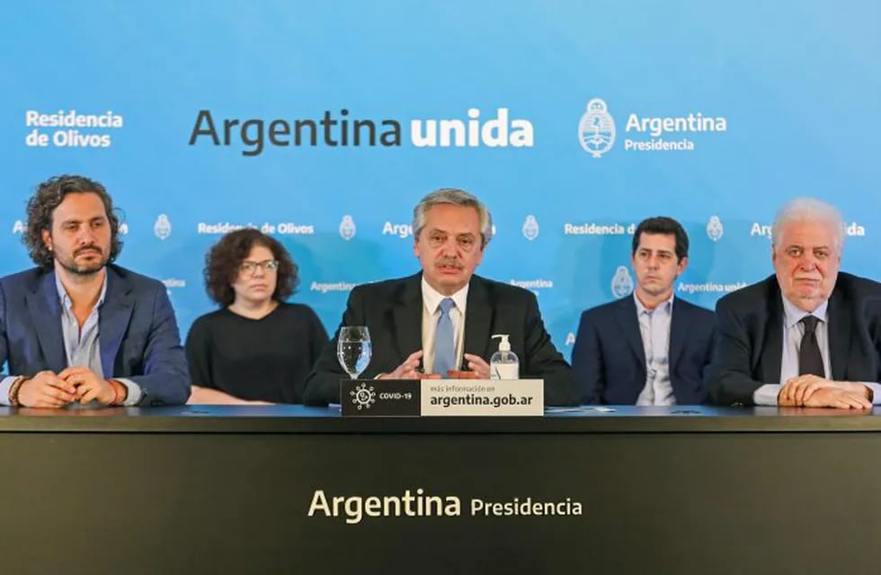 Handout picture released by the Argentina's Presidency showing President Alberto Fernandez (C), flanked by his Health Minister Gines Garcia (R) and his chief cabinet Santiago Cafiero (L), announcing the extension of the \