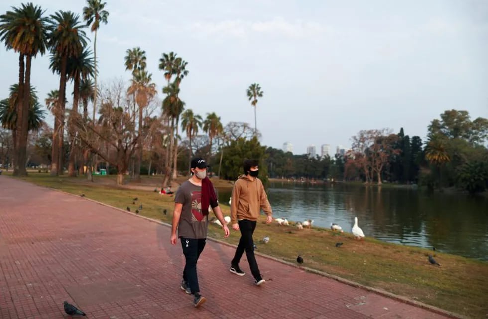 Two men take a walk at the lake in the 3 de Febrero park as the government begins to ease quarantine restrictions imposed to slow the spread of the coronavirus disease (COVID-19), in Buenos Aires, Argentina July 20, 2020. REUTERS/Agustin Marcarian