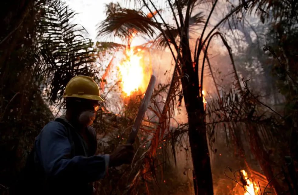 A man fights wildfires in Santa Monica near Concepcion, Bolivia, September 21, 2019. REUTERS/David Mercado