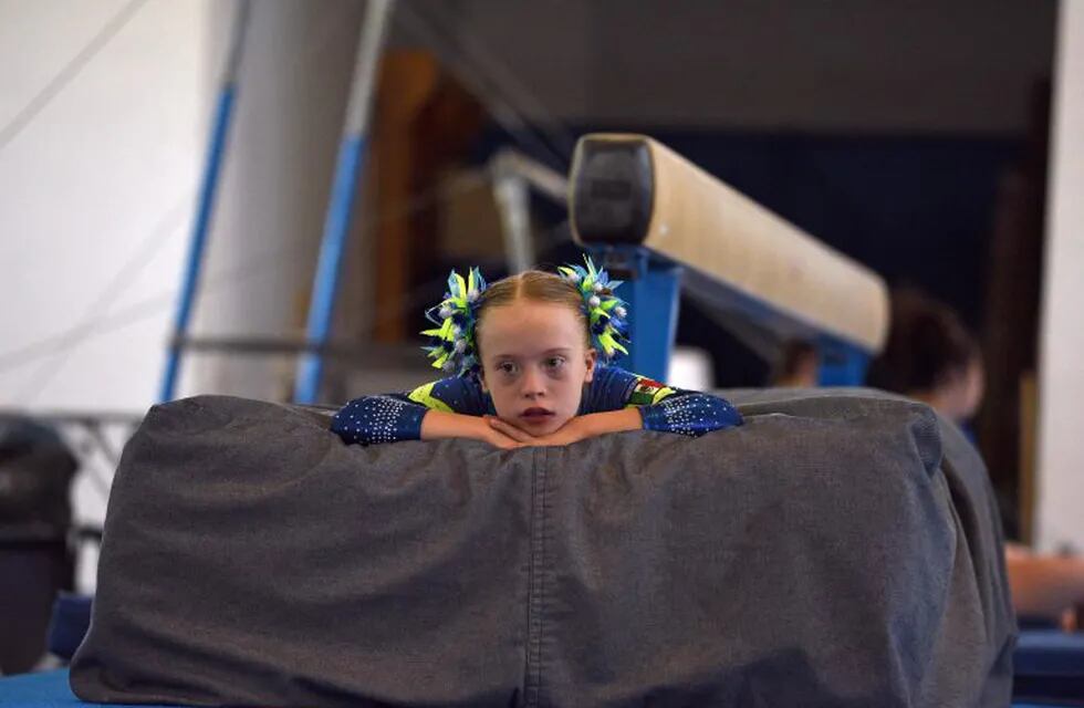 TOPSHOT - A gymnast looks on in Florence on July 18, 2016, during the first World Trisome Games, dedicated exclusively to athletes with Down syndrome.\r\nThe World Trisome Games, dedicated exclusively to athletes with Down syndrome, runs for the first time in Florence from July 15 to 22, featuring athletes from 35 nation that compete in events such as swimming, synchronized swimming, athletics, tennis, table tennis, judo and gymnastic sports. Organized by Sports Union for Athletes with Down Syndrome (SU-DS) has approached the International Paralympic Committee for it to be as a new class within the paralympic games. / AFP PHOTO / Claudio Giovannini italia florencia  italia atletismo juegos mundiales para atletas con sindrome de down atletas con sindrome de down
