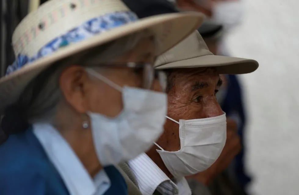 Elderly people wearing protective masks wait to receive an influenza vaccine at a clinic that specializes in respiratory illnesses, in Lima, Peru, Tuesday, March 17, 2020. Peru's President Martin Vizcarra has declared a state of emergency, ordering citizens to stay in their homes and temporarily suspending certain constitutional rights, to contain the spread of coronavirus. The vast majority of people recover from the new virus.  (AP Photo/Martin Mejia)