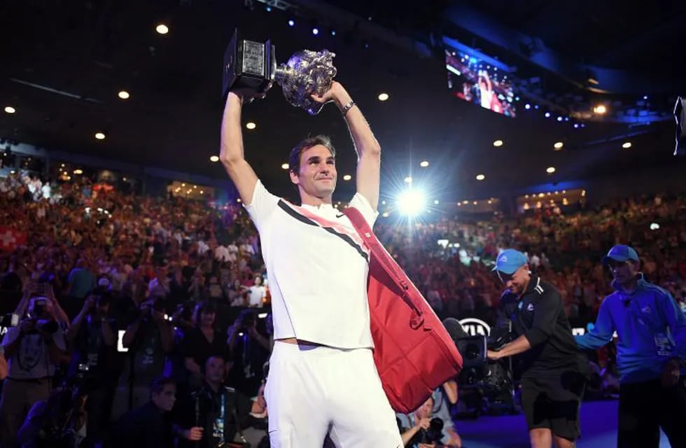 Switzerland's Roger Federer holds his trophy up after defeating Croatia's Marin Cilic in the men's singles final at the Australian Open tennis championships in Melbourne, Australia, Sunday, Jan. 28, 2018. (AP Photo/Andy Brownbill)