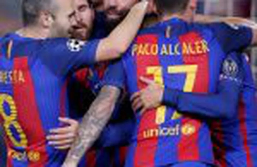 Barcelona's Arda Turan, center, celebrates with team mates after scoring his side's 2nd goal during the Champions League, Group C, soccer match between FC Barcelona and Borussia Moenchengladbach at the Camp Nou stadium in Barcelona, Spain, Tuesday Dec. 6,