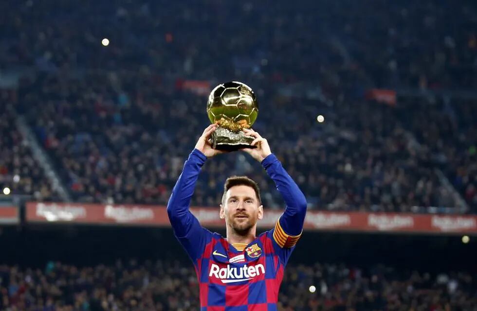 Barcelona's Lionel Messi shows the supporters his sixth Golden Ball for the best player of the year that he was awarded earlier in the week, before a Spanish La Liga soccer match between Barcelona and Mallorca at Camp Nou stadium in Barcelona, Spain, Saturday, Dec. 7, 2019. (AP Photo/Joan Monfort)
