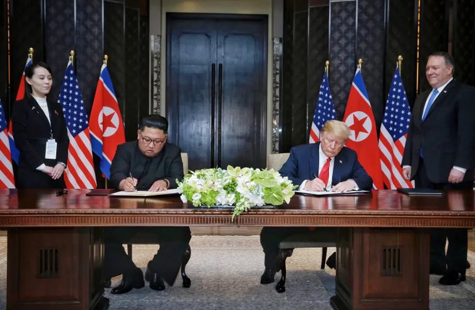 U.S. President Donald Trump reaches to shake hands with North Korea leader Kim Jong Un at the Capella resort on Sentosa Island Tuesday, June 12, 2018 in Singapore. (AP Photo/Evan Vucci)