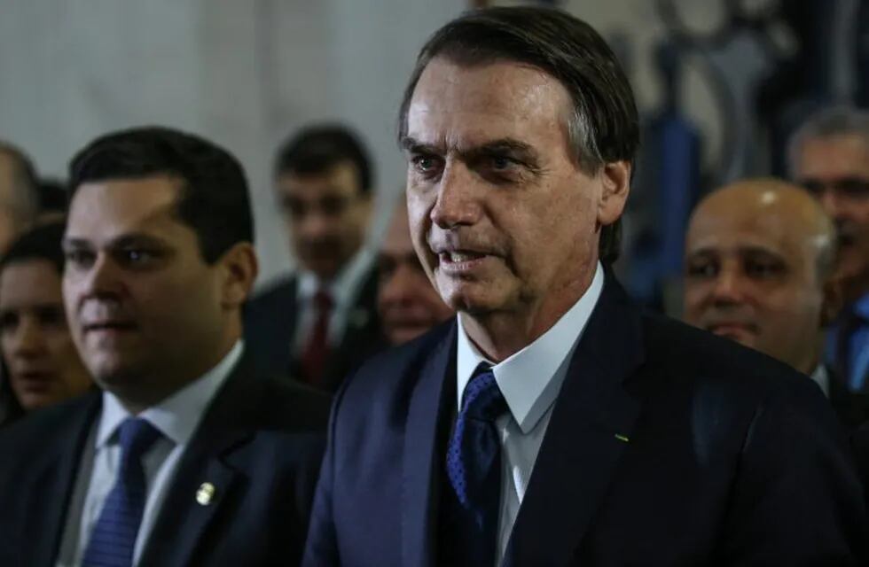 Jair Bolsonaro, Brazil's president, speaks to members of the media before delivering a pension reform proposal at the National Congress in Brasilia, Brazil, on Wednesday, Feb. 20, 2019. The plan holds out big rewards, including estimated savings of up to 1.2 trillion reais ($320 billion) in 10 years, but its potentially tortuous progress will keep investors on edge for months. Photographer: Andre Coelho/Bloomberg