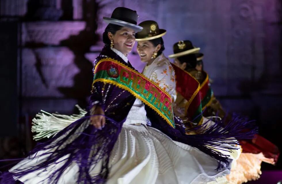 Women parade on the catwalk during the Miss Cholita Paceña 2019, beauty pageant in La Paz, Bolivia, Friday, June 28, 2019. Aymara women participate in the pageant, an annual contest that recognizes indigenous women's fashion and beauty as well as their command of indigenous lifestyle and language.( AP Photo/Juan Karita)