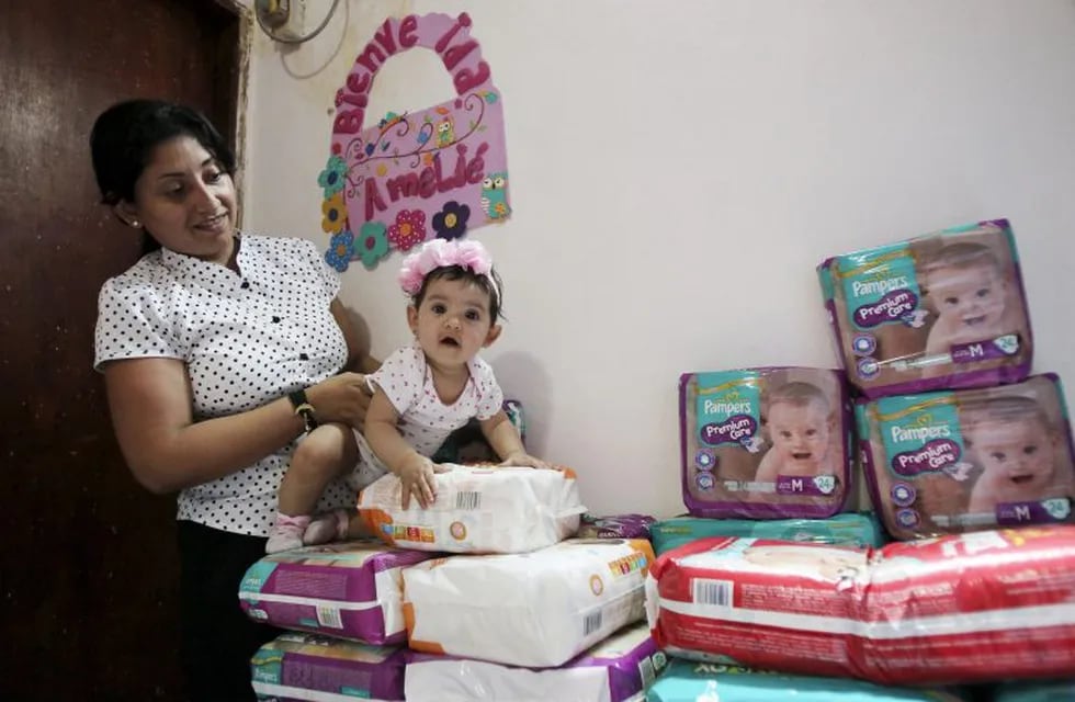 Yeslany Davila plays with her daughter on a pile of diapers she has managed to accumulate at her house in Maracaibo, Venezuela July 3, 2015. Picture taken on July 3, 2015. To match Feature VENEZUELA-MOTHERS/ REUTERS/Isaac Urrutia venezuela maracaibo  informe sobre la maternidad en maracaibo madre acumula pañales en su casa
