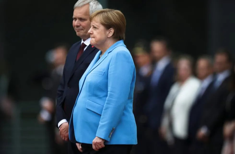 German Chancellor Angela Merkel, right, and Prime Minister of Finland Antti Rinne listen to the national anthems at the chancellery in Berlin, Germany, Wednesday, July 10, 2019. Merkel's body shook visibly as she stood alongside the Finnish prime minister and listen to the national anthems during the welcoming ceremony at the chancellery.(AP Photo/Markus Schreiber)