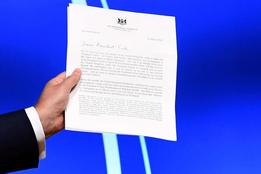 European Council President Donald Tusk holds British Prime Minister Theresa May's formal notice of the UK's intention to leave the bloc under Article 50 of the EU's Lisbon Treaty 
that was delivered to him by Britain's ambassador to the EU, during a press