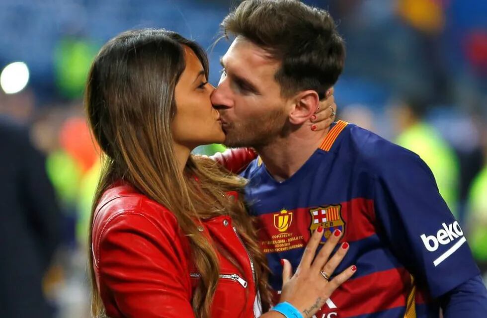 FILE - In this May 22, 2016 file photo, Barcelona's Lionel Messi kisses his girlfriend Antonella Roccuzzo, after winning the final of the Copa del Rey soccer match against Sevilla FC at the Vicente Calderon stadium in Madrid. Messi will be marrying 29-year-old Roccuzzo, his childhood friend and mother of his two children on Friday, June 30, 2017, in his hometown of Rosario, Argentina. (AP Photo/Francisco Seco/ File)