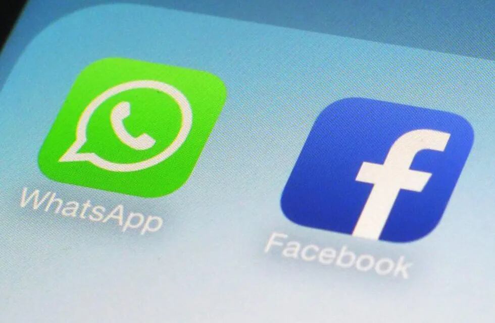 FILE - This Feb. 19, 2014, file photo, shows WhatsApp and Facebook app icons on a smartphone in New York. The EUu2019s competition watchdog has fined Facebook 110 million euros ($122 million) for providing misleading information over its buyout of mobile messaging service WhatsApp. (AP Photo/Patrick Sison, File)