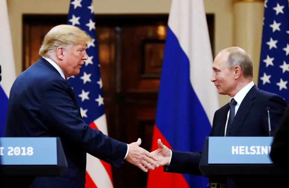 FILE - In this file photo taken on Monday, July 16, 2018, U.S. President Donald Trump, left, shakes hand with Russian President Vladimir Putin at the end of the press conference after their meeting at the Presidential Palace in Helsinki, Finland.  U.S. special counsel Robert Mueller has yet to release his report about Russian meddling in the 2016 U.S. presidential election, but Moscow has already rehearsed its response, dismissing Mueller's investigation as part of the U.S. political infighting. (AP Photo/Alexander Zemlianichenko, File)