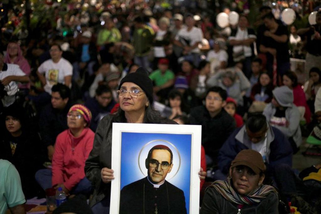 alvadoreños atentos a la transmisión televisiva de la proclamación de San Óscar Arnulfo Romero. (EFE)