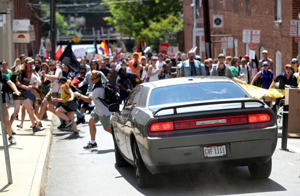 A vehicle drives into a group of protesters demonstrating against a white nationalist rally in Charlottesville, Va., Saturday, Aug. 12, 2017. The nationalists were holding the rally to protest plans by the city of Charlottesville to remove a statue of Confederate Gen. Robert E. Lee. There were several hundred protesters marching in a long line when the car drove into a group of them.   /The Daily Progress via AP)