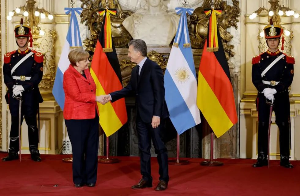 German Chancellor Angela Merkel, left, shakes hands with Argentina's President Mauricio Macri at the government house in Buenos Aires, Argentina, Thursday, June 8, 2017. Merkel is on a official visit to Argentina.(AP Photo/Natacha Pisarenko)