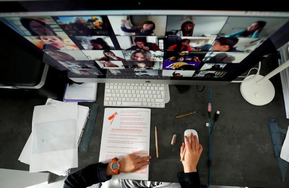 FILE PHOTO: A student takes classes online with his companions using the Zoom app at home during the coronavirus disease (COVID-19) outbreak in El Masnou, north of Barcelona, Spain April 2, 2020. REUTERS/ Albert Gea/File Photo
