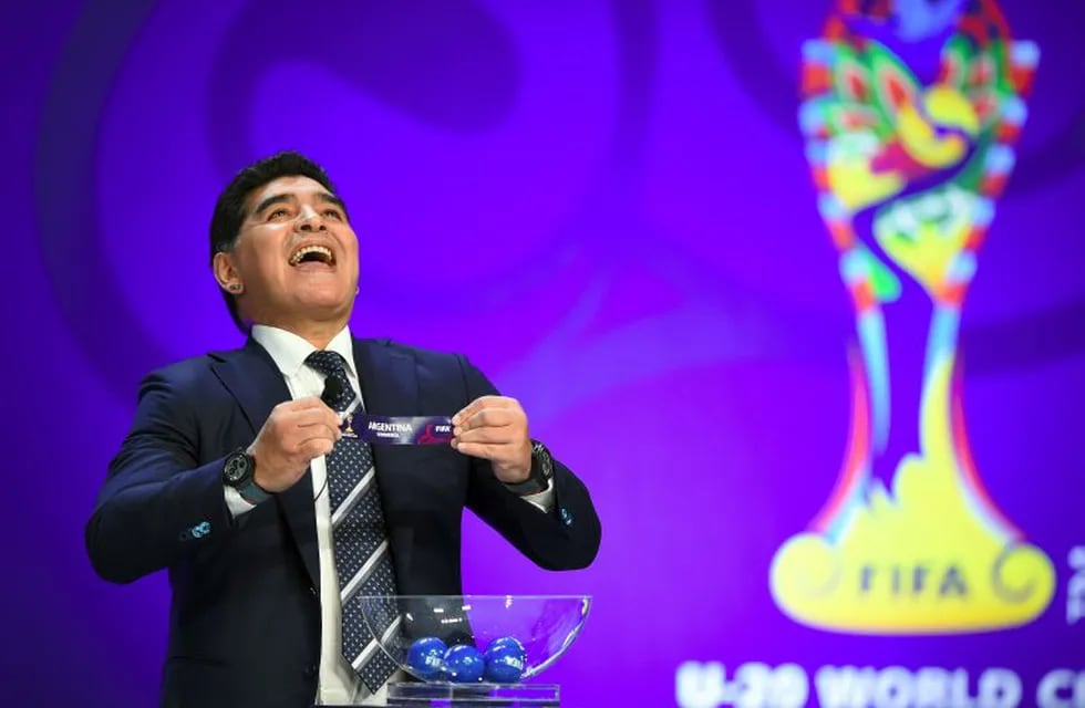 TOPSHOT - Argentinian football star Diego Maradona reacts as he holds the name of Argentina during the official draw for the FIFA under-20 football World Cup in Suwon, south of Seoul, on March 15, 2017.nThe FIFA U-20 World Cup will be held in South Korea 