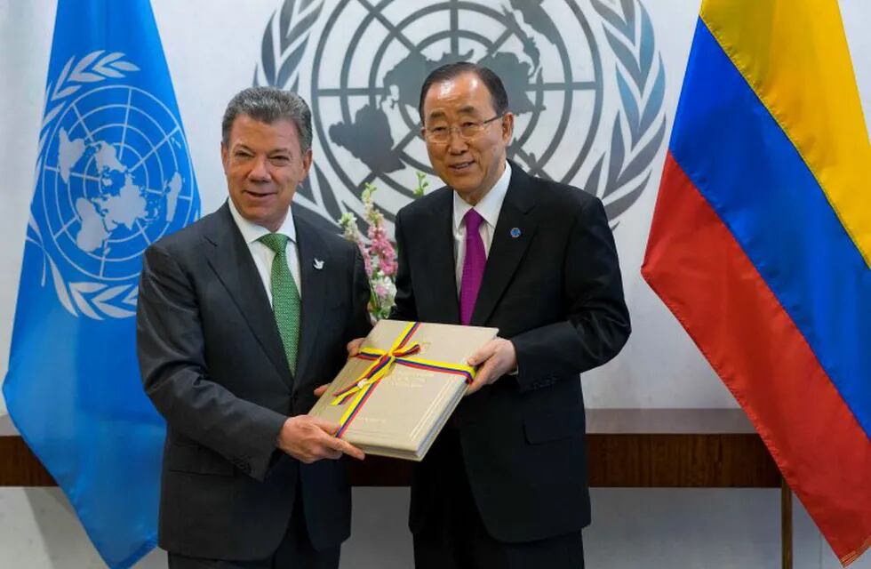 FILE - In this Monday, Sept. 19, 2016 file photo President Juan Manuel Santos of Colombia, left,  presents a copy of a peace agreement that was forged in his country to United Nations Secretary-General Ban Ki-moon during a meeting at the United Nations headquarters. Colombian President Juan Manuel Santos has won Nobel Peace Prize it was announced on Friday Oct. 7, 2016.  (AP Photo/Craig Ruttle)