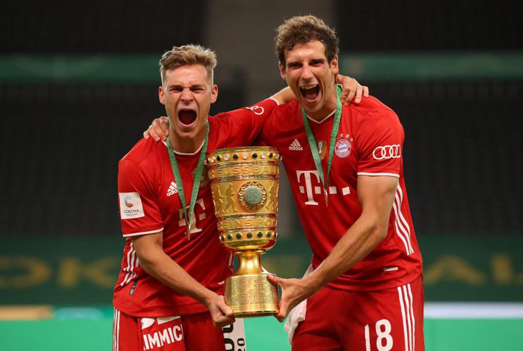 Bayern Munich's German midfielder Joshua Kimmich (L) and Bayern Munich's German midfielder Leon Goretzka celebrate with the German Cup (DFB Pokal) trophy after winning the final football match Bayer 04 Leverkusen v FC Bayern Munich at the Olympic Stadium in Berlin on July 4, 2020\u002E (Photo by Alexander Hassenstein / POOL / AFP) / DFB REGULATIONS PROHIBIT ANY USE OF PHOTOGRAPHS AS IMAGE SEQUENCES AND QUASI-VIDEO\u002E
