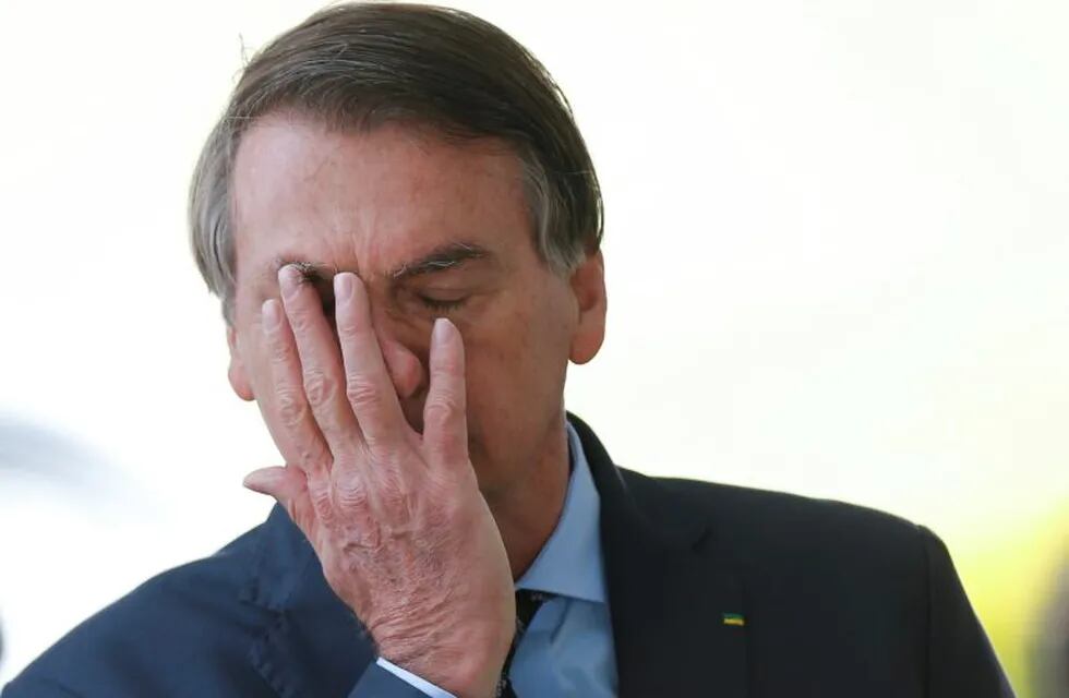 Brazil's President Jair Bolsonaro reacts while meeting supporters as he leaves Alvorada Palace, amid the coronavirus disease (COVID-19) outbreak, in Brasilia, Brazil, April 9, 2020. REUTERS/Adriano Machado