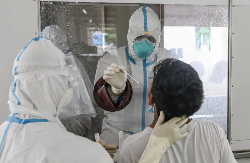 A medical staff take a swab sample of a journalist to test for COVID-19 coronavirus at a quarantine facility in Hlaing University in Yangon in preparation the 73rd anniversary of Martyrs' Day ceremony on July 16, 2020. (Photo by Ye Aung THU / AFP)
