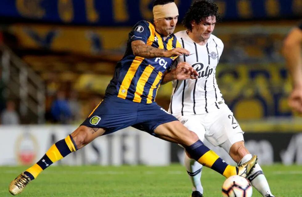 Argentina's Rosaria Central German Herrera (L) vies for the ball with Paraguay's Libertad Blas Caceres during their Copa Libertadores football match at Gigante de Arroyito stadium, in Rosario, Argentina, on May 8, 2019. (Photo by HECTOR RIO / AFP)