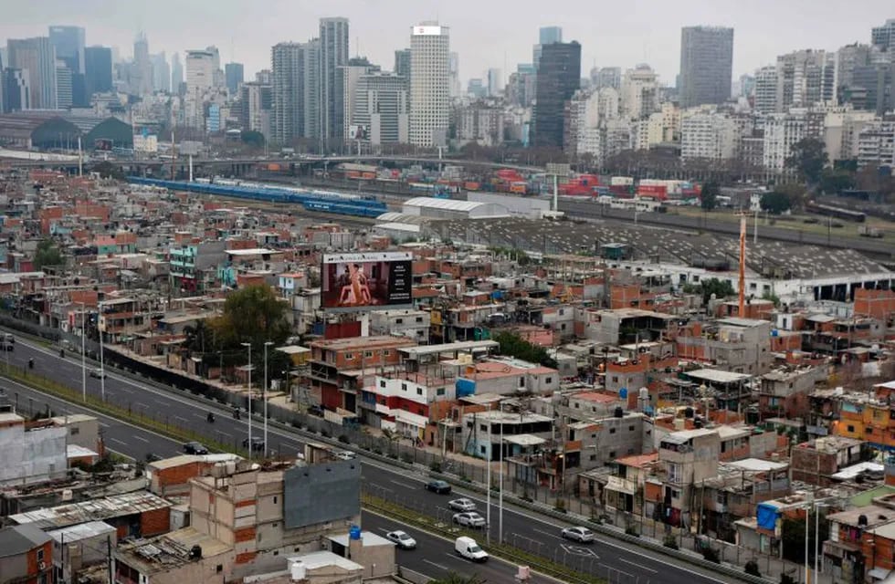 View of the Villa 31 shantytown with the upscale Recoleta neighborhood in the background in Buenos Aires, Argentina, on June 22, 2017.  \r\n40.000 inhabitants survive in the Villa 31 shantytown amid muddy streets, small brick homes without foundations and minimum basic services. The oldest shantytown in Buenos Aires, separated from exclusive neighborhoods of the capital only by an avenue, is now aiming to reach urban “comfort”. / AFP PHOTO / Eitan ABRAMOVICH / TO GO WITH AFP STORY BY PAULA BUSTAMANTE ciudad de buenos aires  vistas de la villa 31 villas de emergencia pobreza crisis social