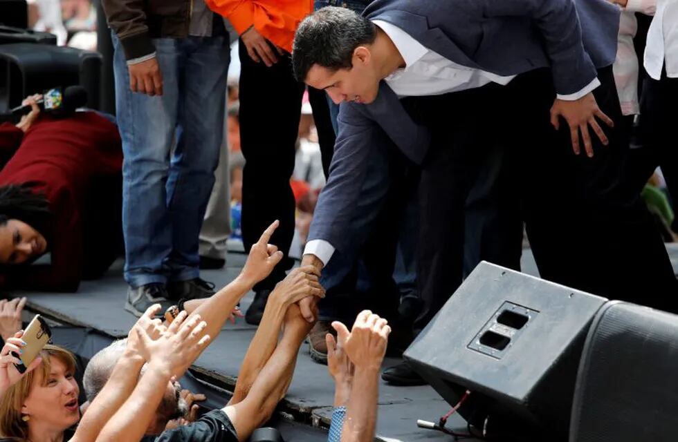FILE PHOTO: Juan Guaido, President of the Venezuelan National Assembly and lawmaker of the opposition party Popular Will (Voluntad Popular), greets supporters during a gathering in Caracas, Venezuela January 11, 2019. REUTERS/Manaure Quintero/File Photo
