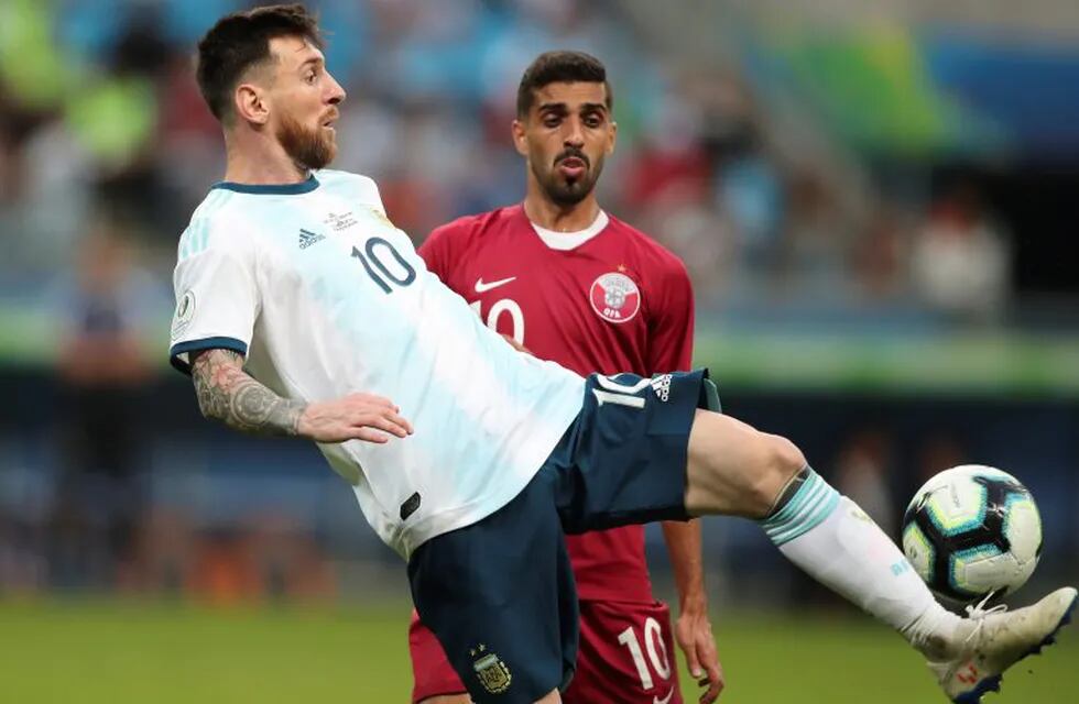 Argentina's Lionel Messi controls the ball as Qatar's Hassan Al Haydos looks on during a Copa America Group B soccer match at the Arena do Gremio in Porto Alegre, Brazil, Sunday, June 23, 2019. (AP Photo/Edison Vara)