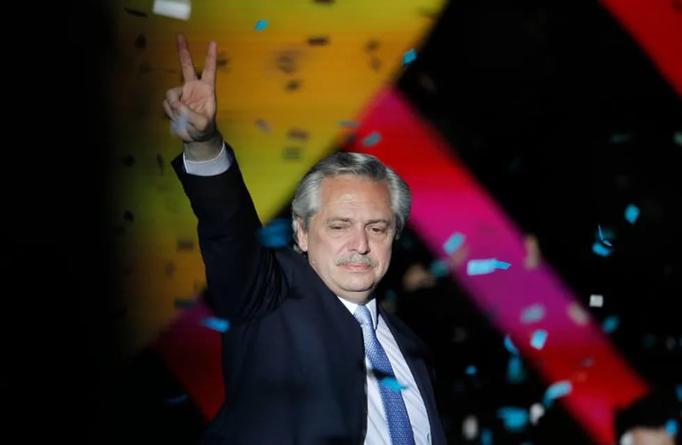TOPSHOT - CORRECTION - Argentina's new President Alberto Fernandez (L) flashes the victory sign during the inauguration ceremony at Plaza de Mayo square in Buenos Aires on December 10, 2019. - Center-leftist Alberto Fernandez vowed to put his people first ahead of debt repayments after he was sworn in as Argentina's president on Tuesday to singing and applause from lawmakers and supporters. (Photo by Emiliano Lasalvia / AFP) / “The erroneous mention[s] appearing in the author metadata of this photo has been modified in AFP systems in the following manner: [Emiliano Lasalvia] instead of [Juan Mabromata]. Please immediately remove the erroneous mention[s] from all your online services and delete it (them) from your servers. If you have been authorized by AFP to distribute it (them) to third parties, please ensure that the same actions are carried out by them. Failure to promptly comply with these instructions will entail liability on your part for any continued or post notification usage